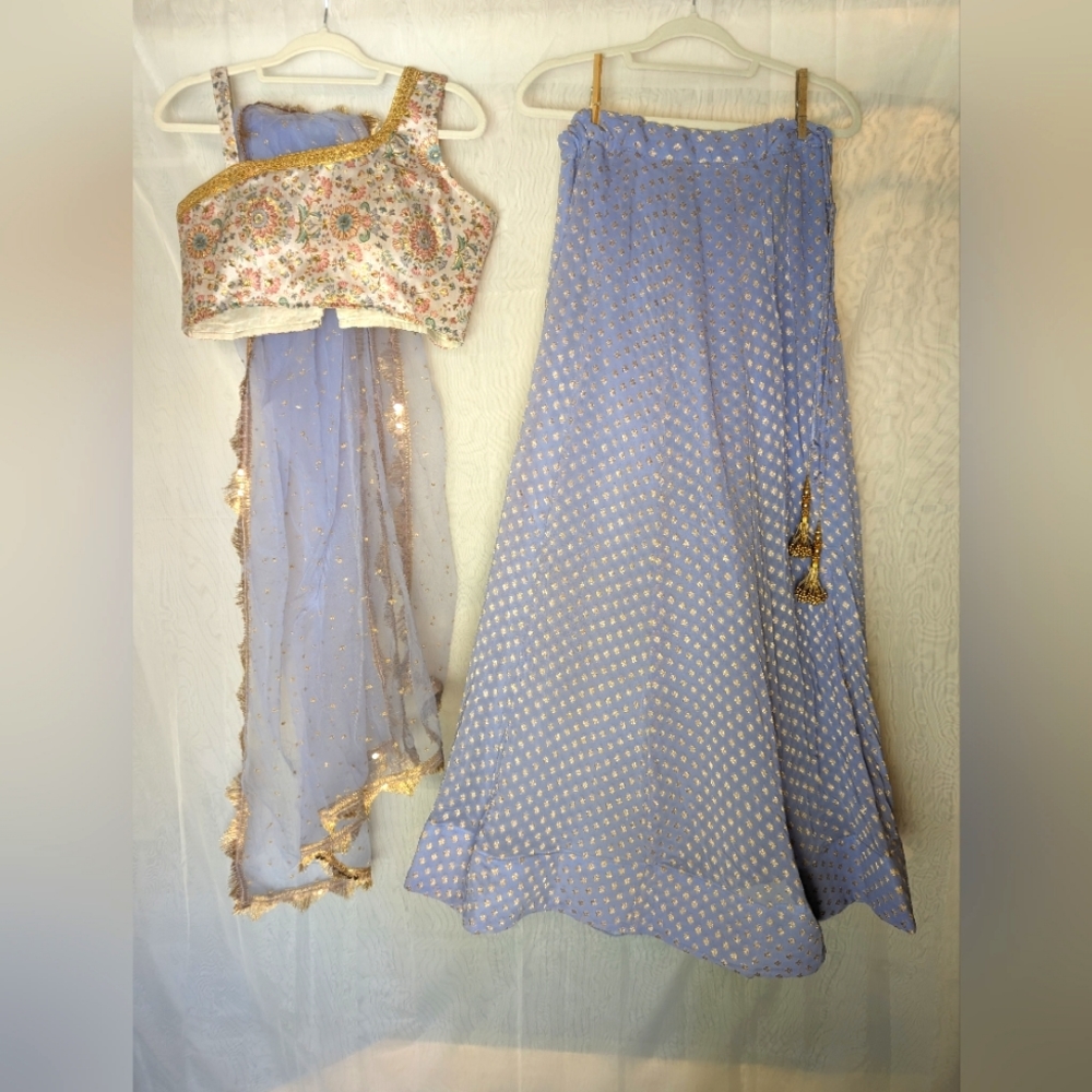Lehenga, choli, dupatta set. Periwinkle blue with gold accents.